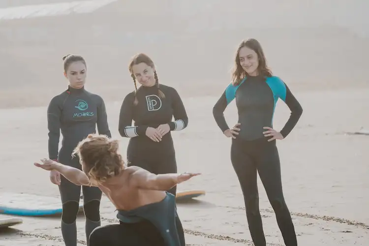 Surf coaching session on the beach in Tamraght Agadir with instructor guiding beginners