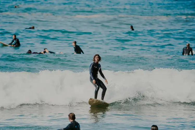 Surfer riding a wave in Agadir Morocco with others waiting in the lineup
