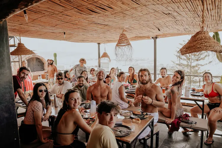 Shared dinner table at sunset in Tamraght Morocco with surfers connecting after the day